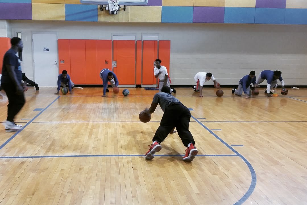 Young people playing basketball with Royal Athletes at a youth rehabilitation center
